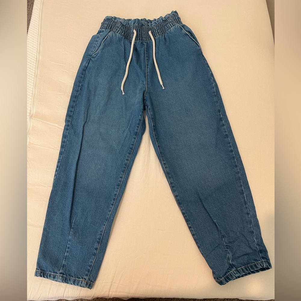Blue jeans with a stretchy waistband. Size US M. Straight legged bottoms.